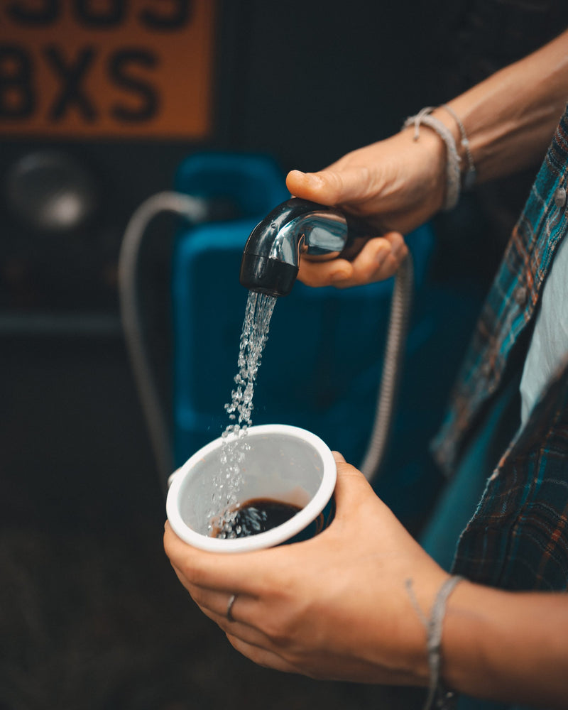 Load image into Gallery viewer, Rinsing a dirty cup with purified water