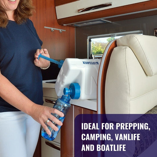 A woman filling a glass with water from a LifeSaver Cube in a caravan