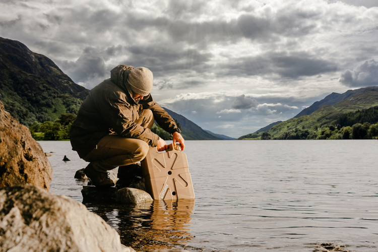 Man filling LifeSaver Jerrycan from Scottish loch