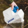 LifeSaver Cube being used to filter river water