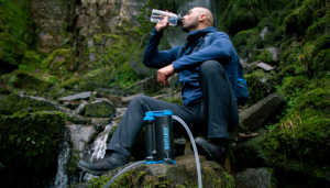 safest hiking water purifier - lifesaver wayfarer. Hiker drinking water form bottle